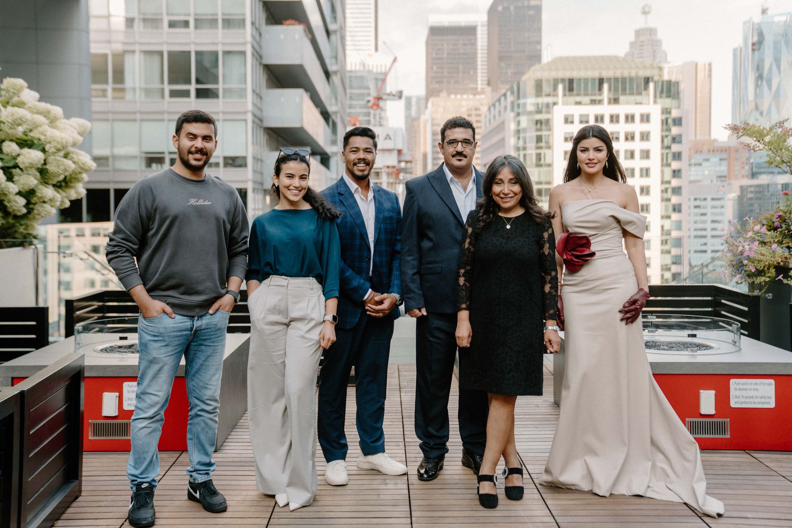 Group portrait of five creative professionals on Toronto rooftop terrace with downtown skyline during brand photography shoot by Origin Films