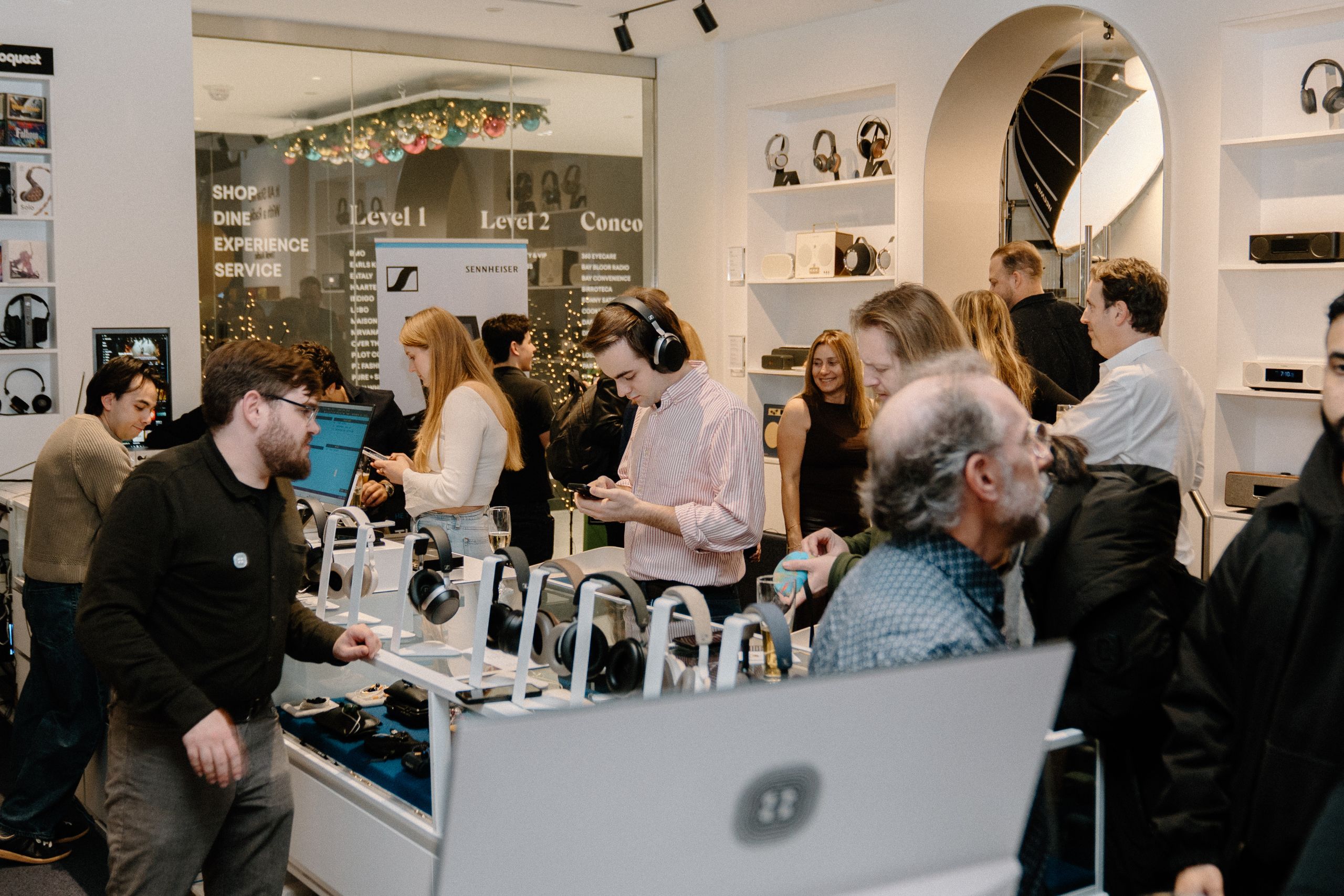 Sennheiser store retail product launch event photography showing customers trying premium headphones at Sennheiser shop in Toronto captured by Origin Films event photography
